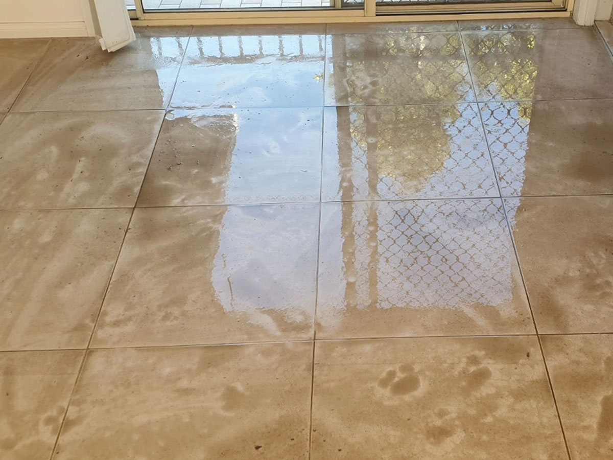 A dull, worn marble floor before restoration